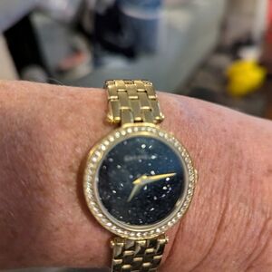 Ladies gold bullova cavallere watch with black speckled face